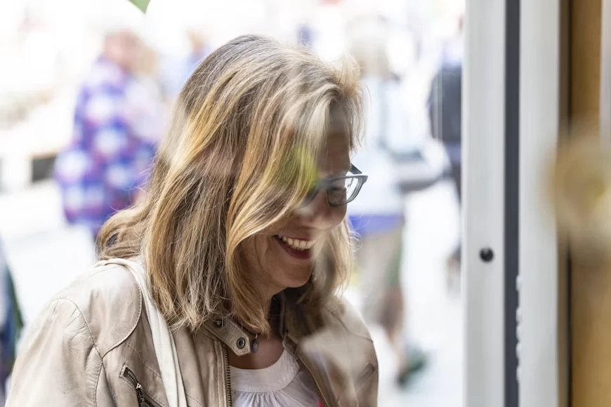 Middle-aged woman wearing glasses smiling